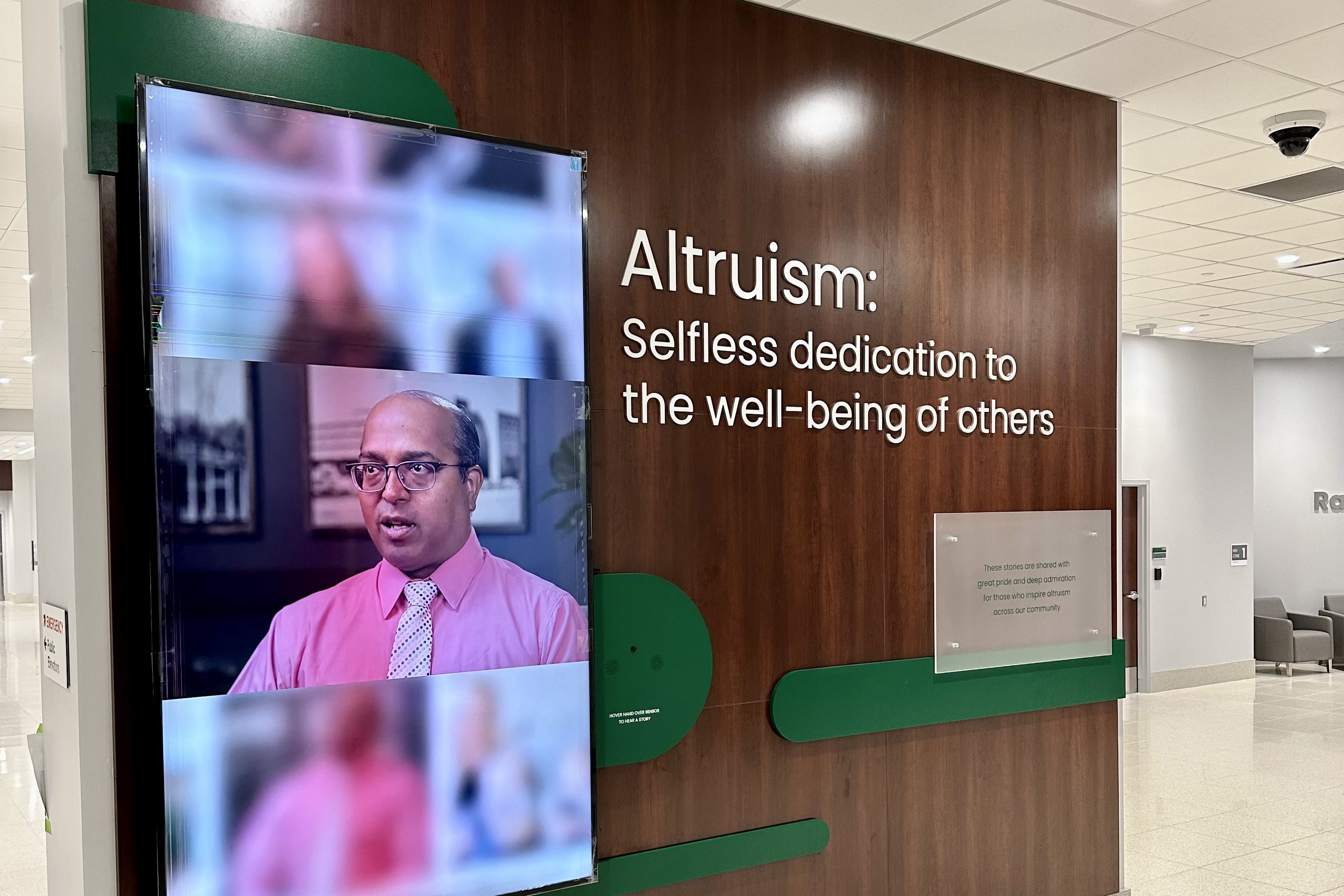 Large 100" video display shuffles through stories of patients, donors and staff